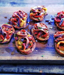 Roasted red pepper and anchovy salad on roasted garlic toasts